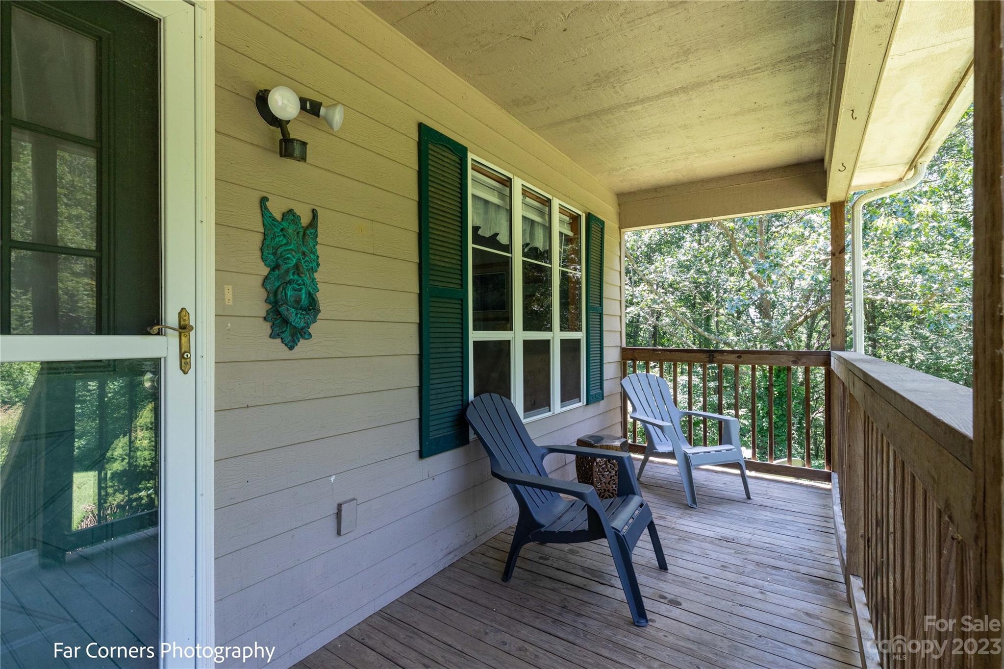 1454 Sorrells Cove Road Clyde, NC 28721 - Photo 5 of 26 a view of a balcony with furniture and wooden floor