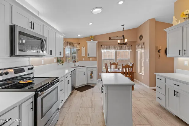 a kitchen with a sink appliances and cabinets