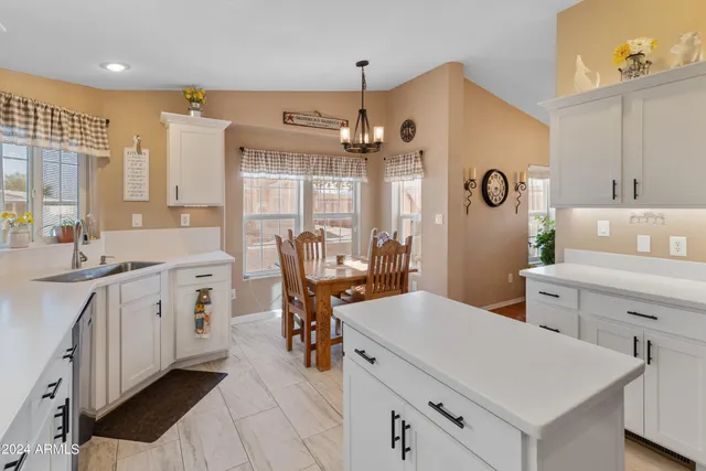 a kitchen with cabinets stainless steel appliances and a window