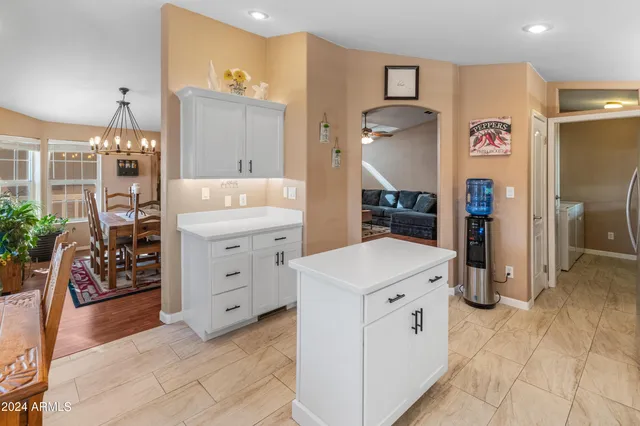 a dining room with furniture a chandelier and wooden floor