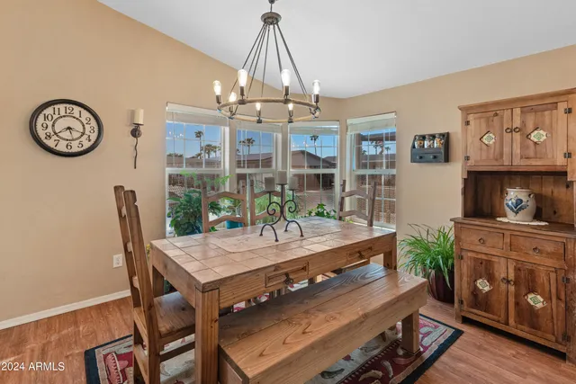 a view of a dining room with furniture and a chandelier