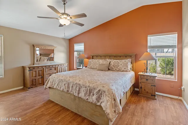 a bedroom with a large bed and a chandelier