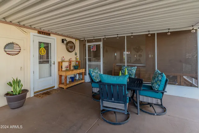a living room with furniture a flat screen tv and floor to ceiling window
