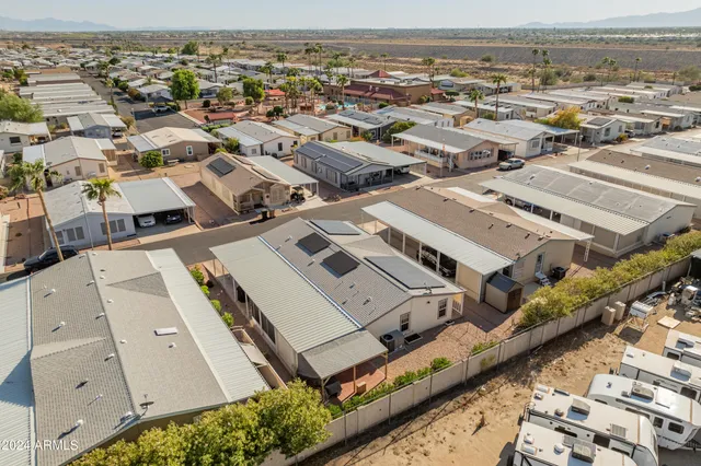a patio with table and chairs with potted plants
