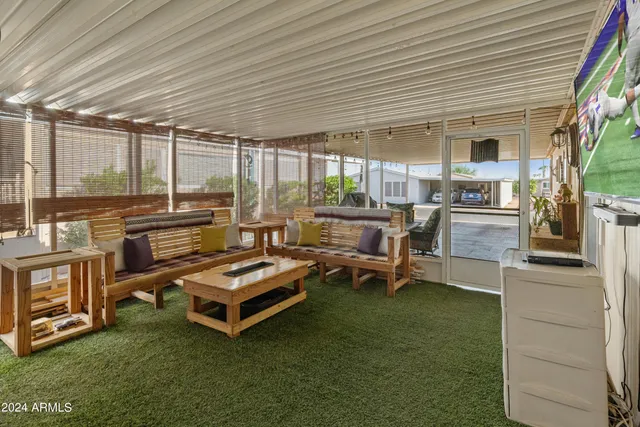 a living room with furniture a table and chairs