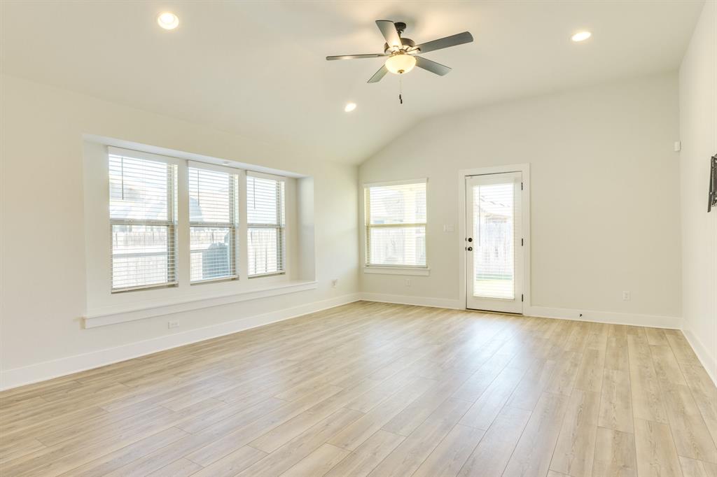 122 Biscayne Bay Bend Kyle, TX 78640 - Photo 10 of 29 an empty room with wooden floor fan and windows