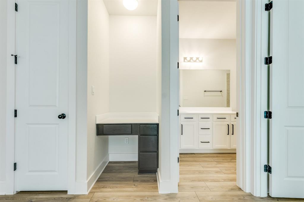 122 Biscayne Bay Bend Kyle, TX 78640 - Photo 23 of 29 an empty room with wooden floor mirror and sink
