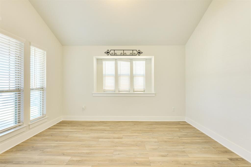 122 Biscayne Bay Bend Kyle, TX 78640 - Photo 5 of 29 a view of an empty room with wooden floor and a window