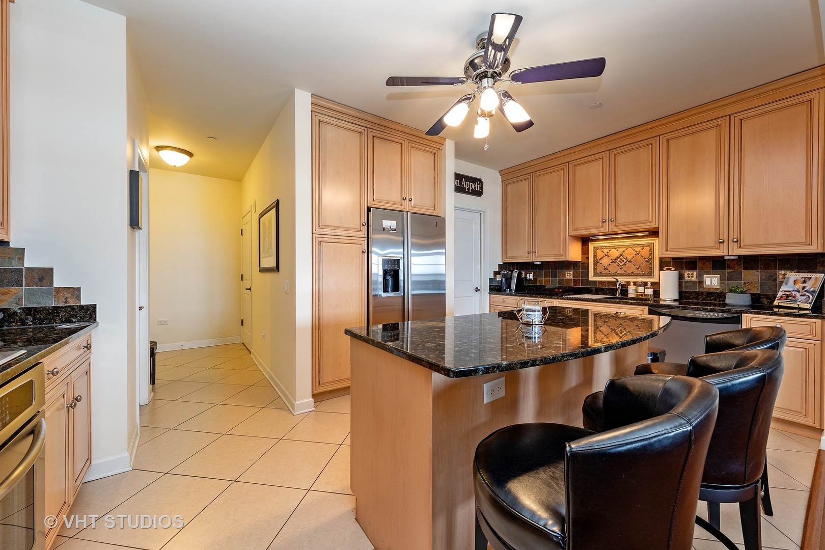151 West Wing Street, Unit 506 Arlington Heights, IL 60005 - Photo 5 of 13 a kitchen with stainless steel appliances granite countertop a sink a stove and a refrigerator