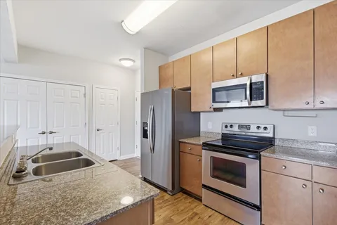 a kitchen with a sink stove and refrigerator