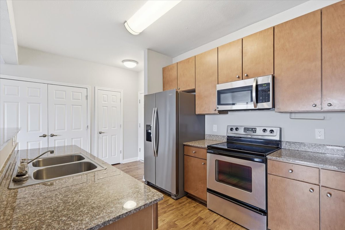 2502 Leon Street, Unit 414 Austin, TX 78705 - Photo 5 of 21 a kitchen with a sink stove and refrigerator