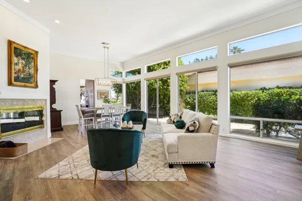 a living room with furniture a fireplace and a table