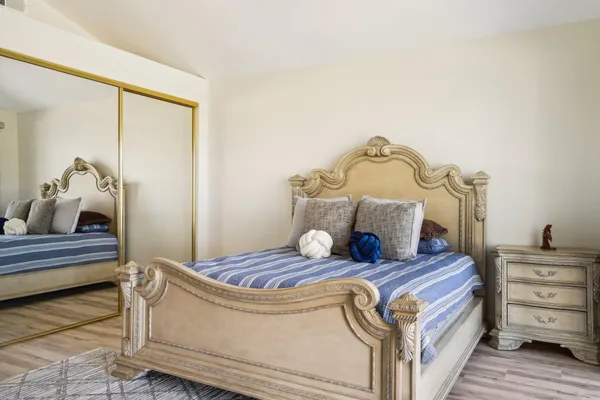 a view of a room with wooden floor and bathroom