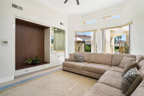a view of a patio with couches chairs and a potted plant