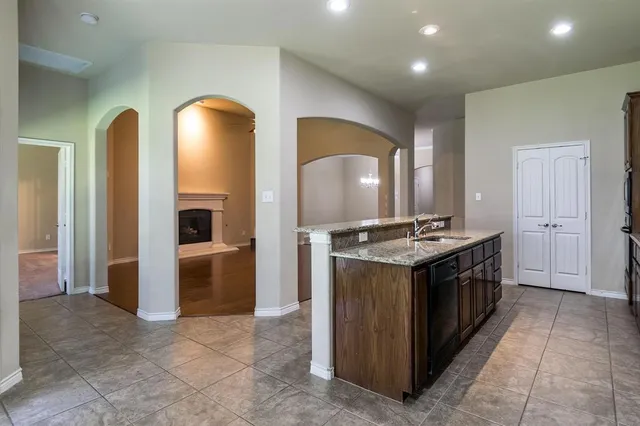 a kitchen with stainless steel appliances granite countertop a stove and a sink