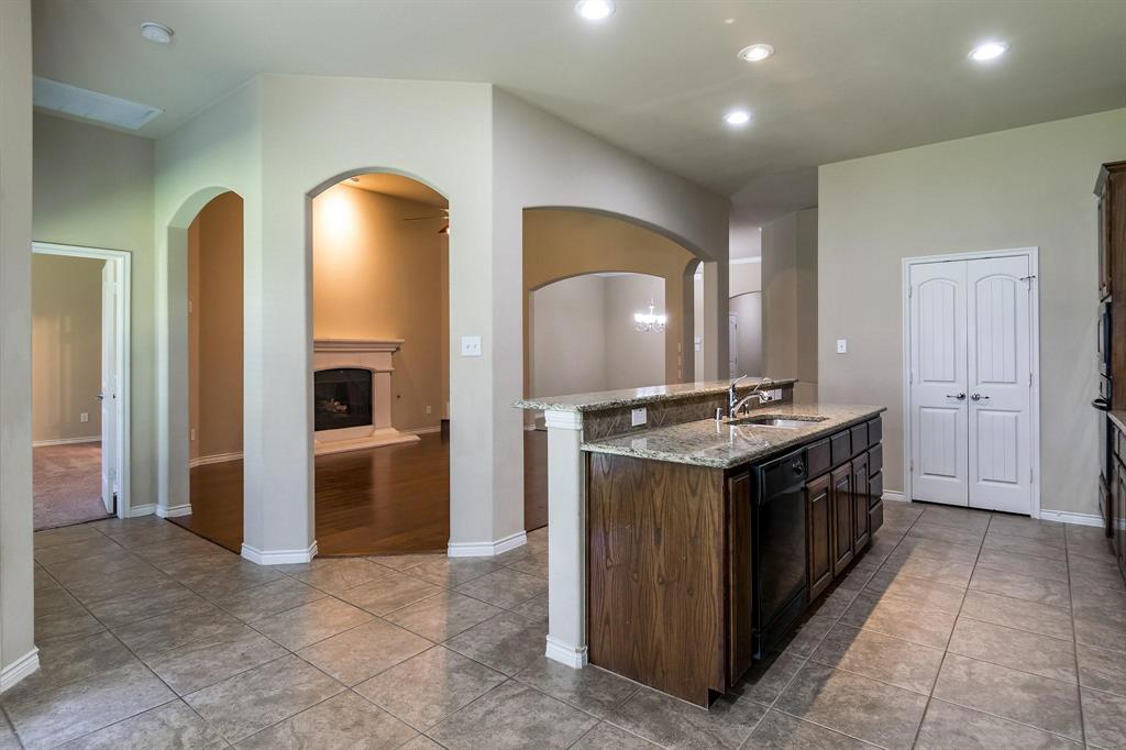 10104 Waterstone Way McKinney, TX 75072 - Photo 11 of 29 a kitchen with stainless steel appliances granite countertop a stove and a sink