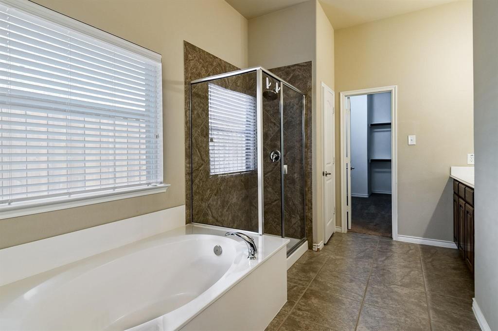10104 Waterstone Way McKinney, TX 75072 - Photo 12 of 29 a bathroom with a bathtub and a shower