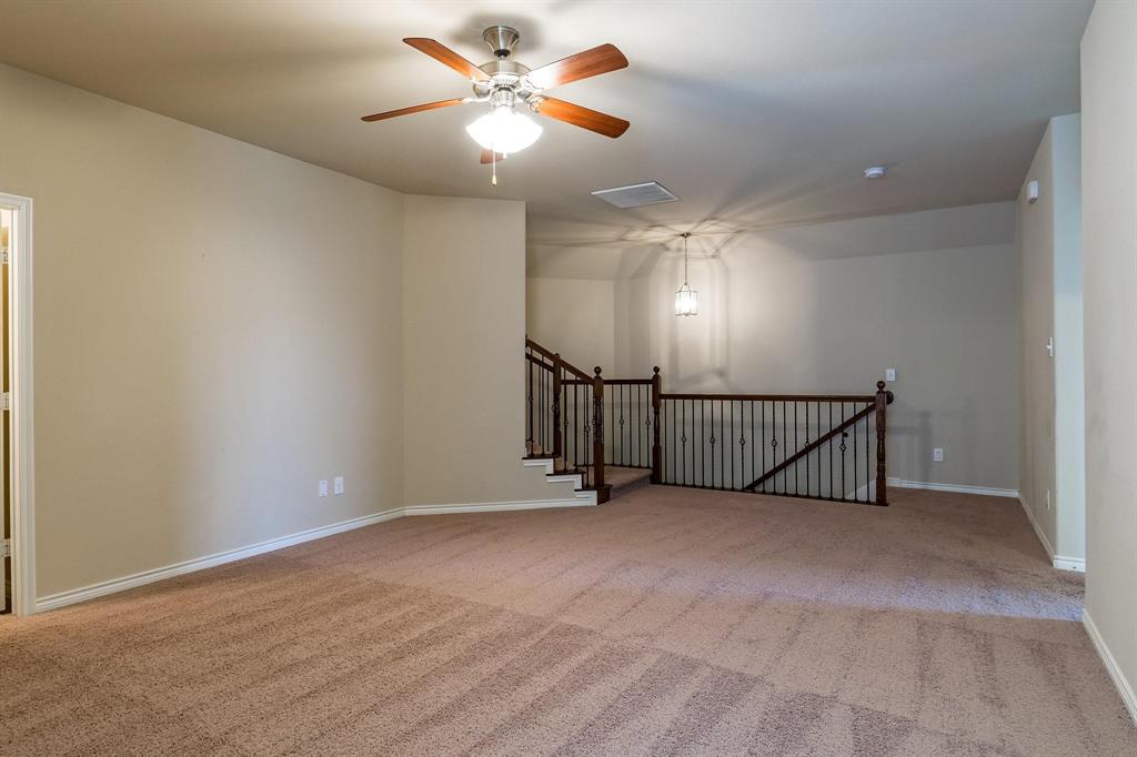 10104 Waterstone Way McKinney, TX 75072 - Photo 15 of 29 a view of an empty room with a chandelier fan