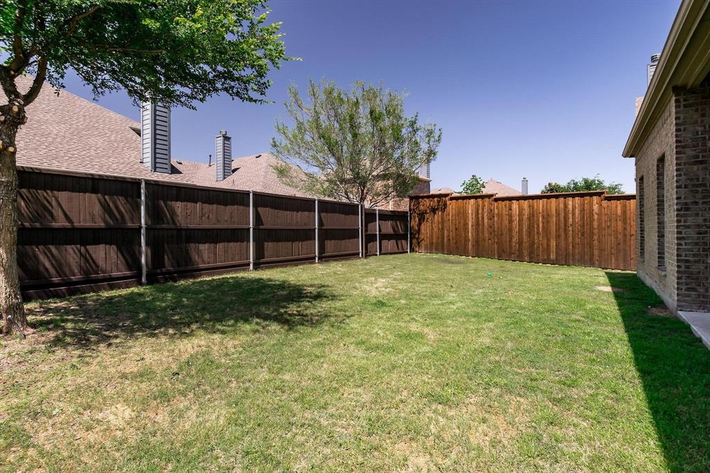 10104 Waterstone Way McKinney, TX 75072 - Photo 18 of 29 a view of a backyard with a large tree and wooden fence