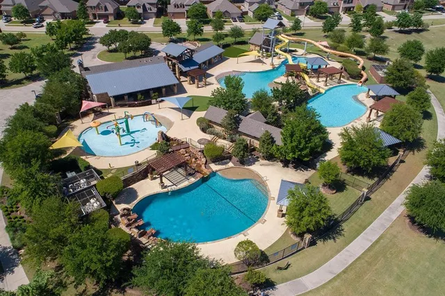 an aerial view of residential house with outdoor space and parking