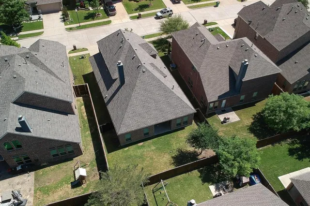 an aerial view of a house with a swimming pool and outdoor seating