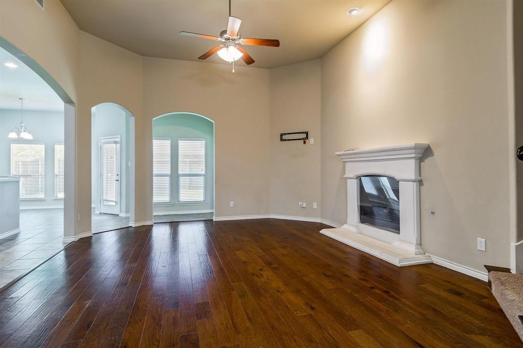 10104 Waterstone Way McKinney, TX 75072 - Photo 5 of 29 a view of an empty room with window and wooden floor