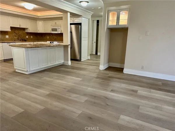 a kitchen with stainless steel appliances granite countertop a stove and a refrigerator