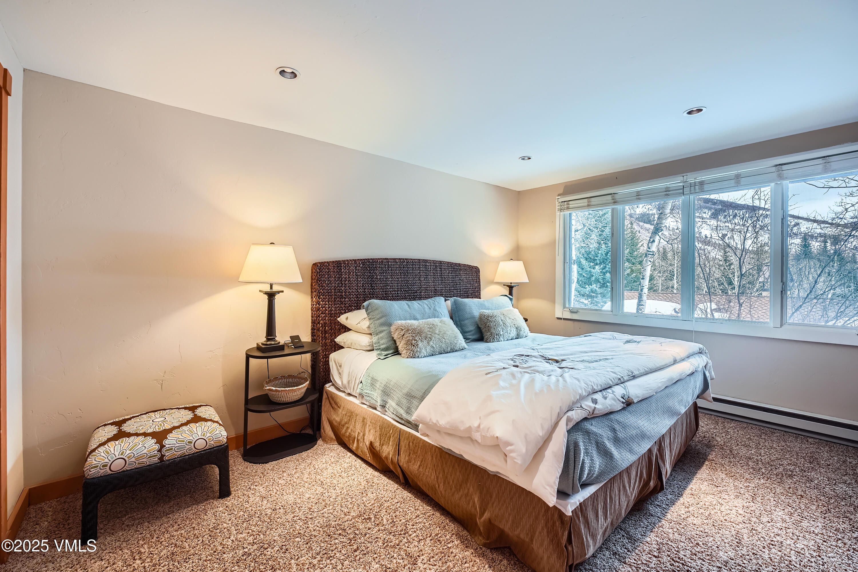 2875 Manns Ranch Road, Unit J2 Vail, CO 81657 - Photo 18 of 25 a bedroom with a bed and a large window