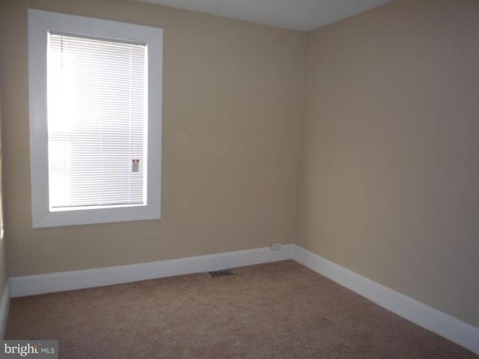 3905 Bonner Road Baltimore, MD 21216 - Photo 13 of 17 an empty room with a window