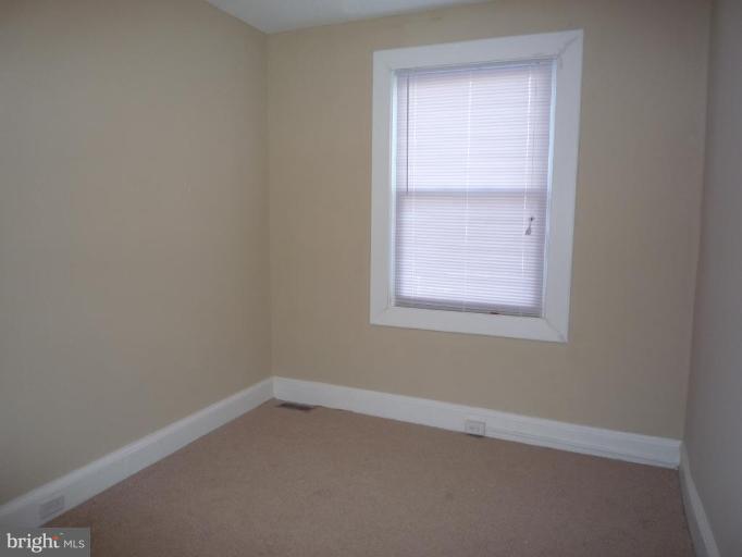 3905 Bonner Road Baltimore, MD 21216 - Photo 9 of 17 an empty room with a window