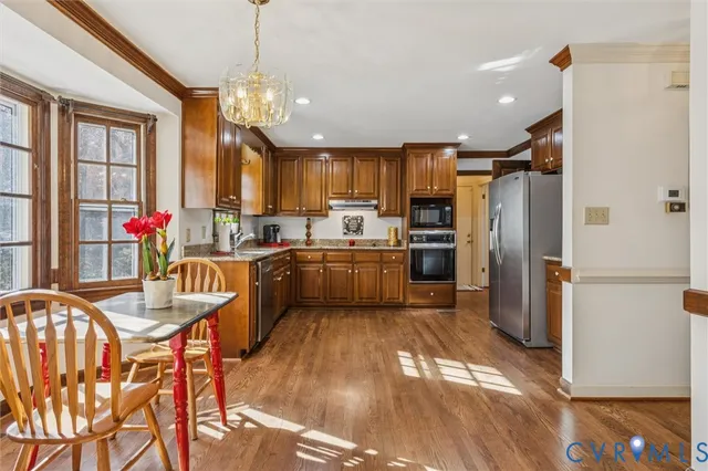 a kitchen with refrigerator a sink and cabinets