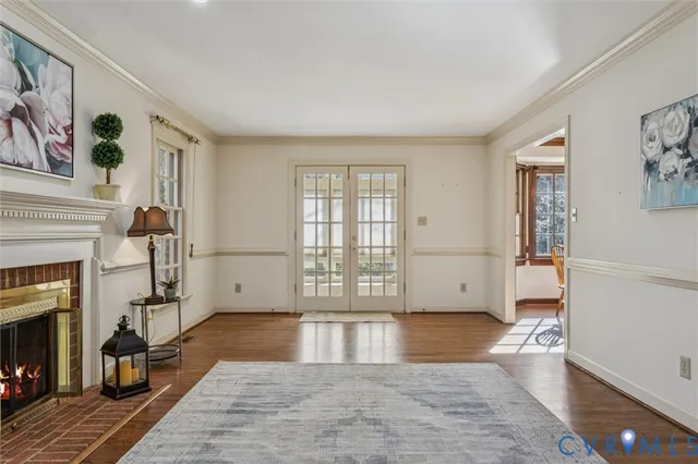 a view of empty room with wooden floor and fireplace