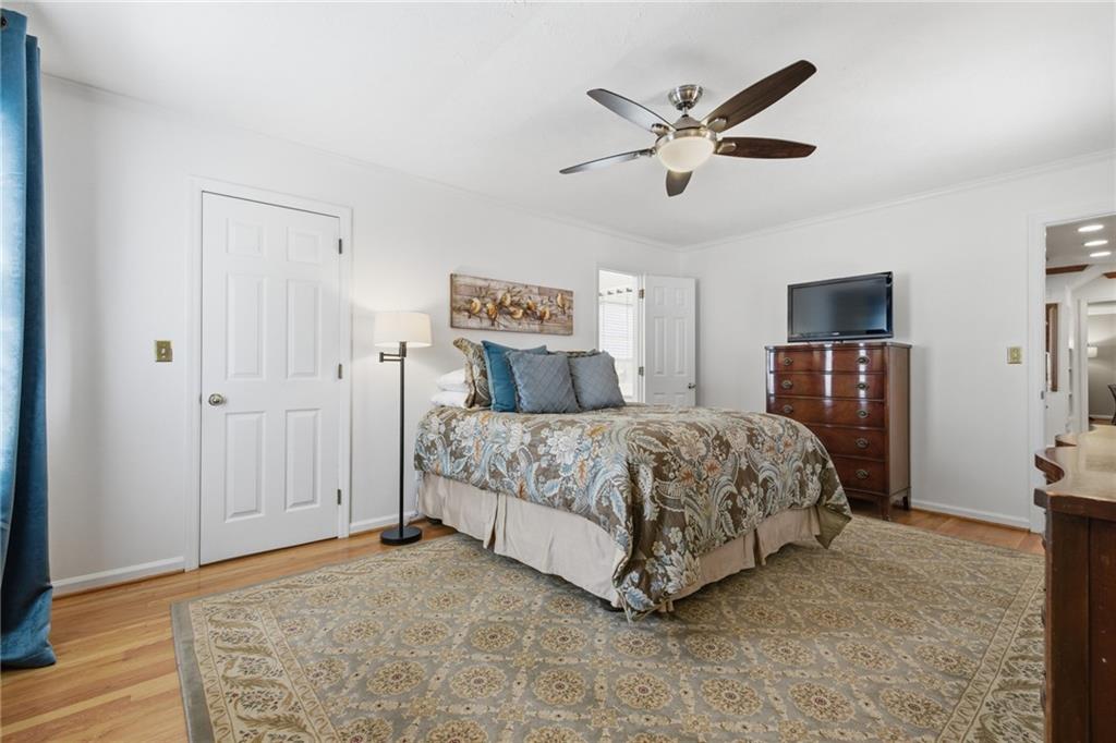 1924 Queens Way Atlanta, GA 30341 - Photo 34 of 88 a bedroom with a large bed a chandelier and closet