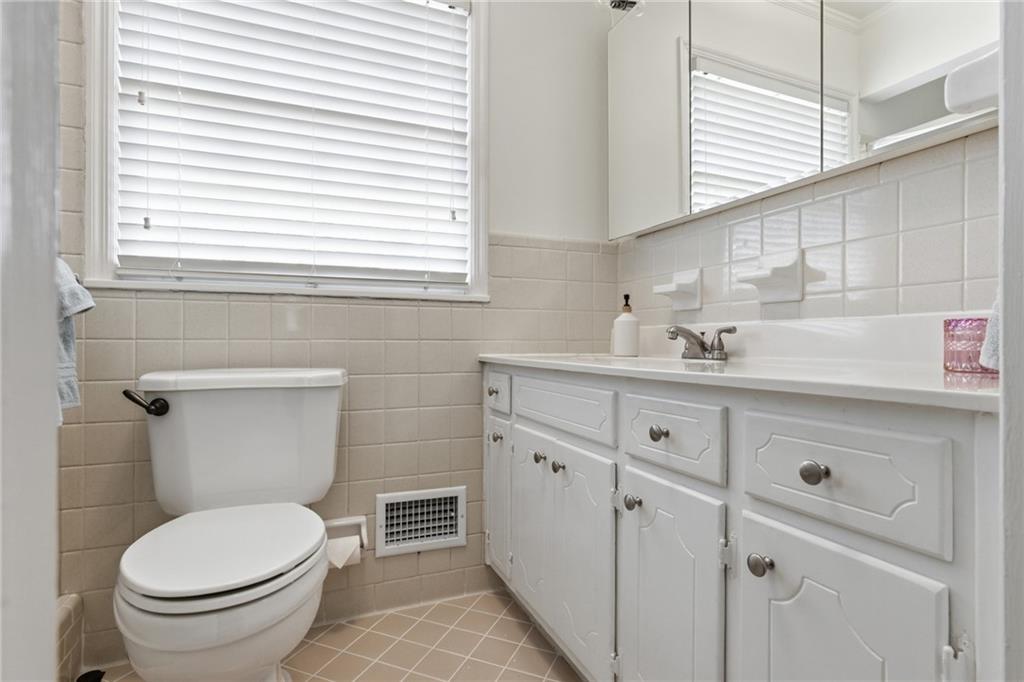 1924 Queens Way Atlanta, GA 30341 - Photo 38 of 88 a bathroom with a toilet sink and mirror