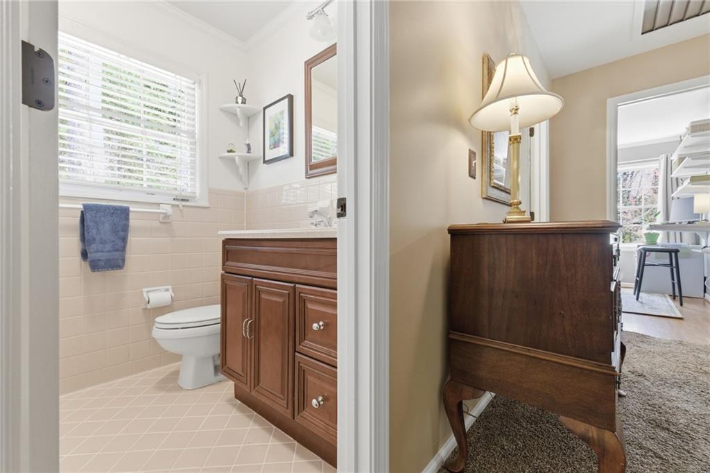 1924 Queens Way Atlanta, GA 30341 - Photo 49 of 88 a bathroom with a toilet sink and mirror