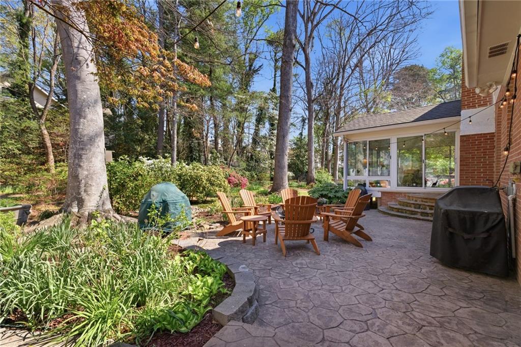 1924 Queens Way Atlanta, GA 30341 - Photo 61 of 88 a view of a patio with chair table and chairs and potted plants