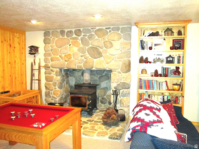 6210 Mountain View Road, Unit 133 Coalville, UT 84017 - Photo 58 of 87 A wood burning stove heats the whole cabin in the winter and has a gray river rock hearth and pedestal.