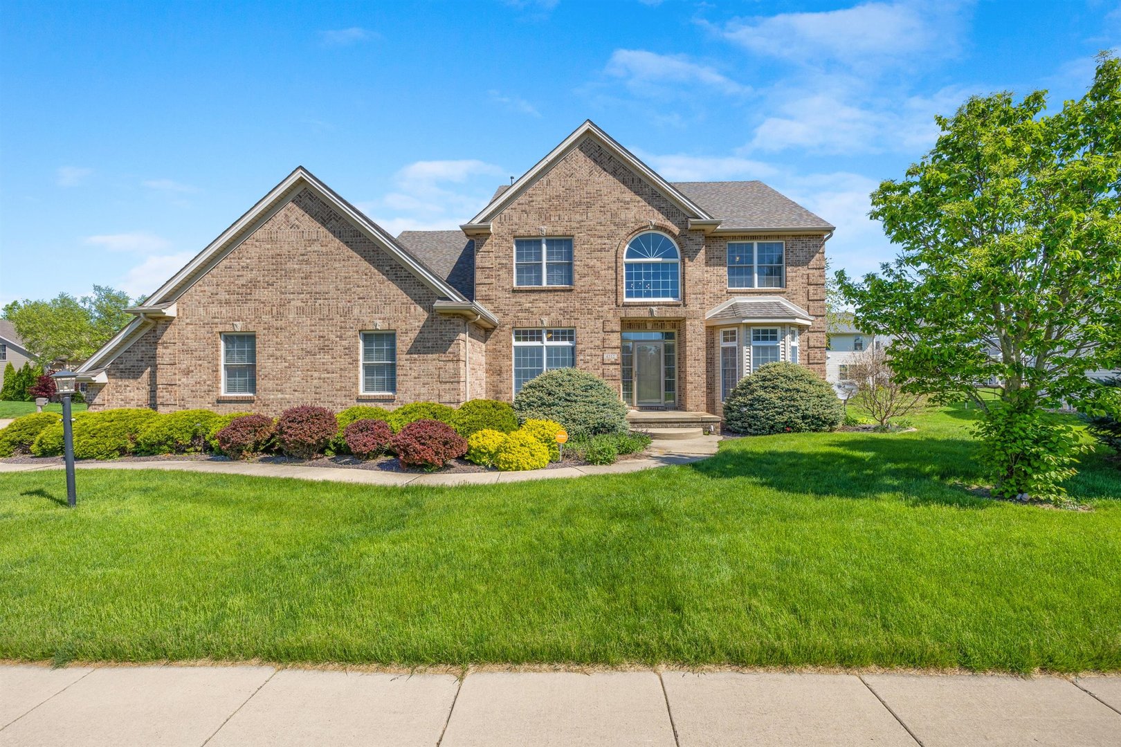 4512 Doverbrook Drive Champaign, IL 61822 - Photo 1 of 62 a front view of a house with a garden and yard
