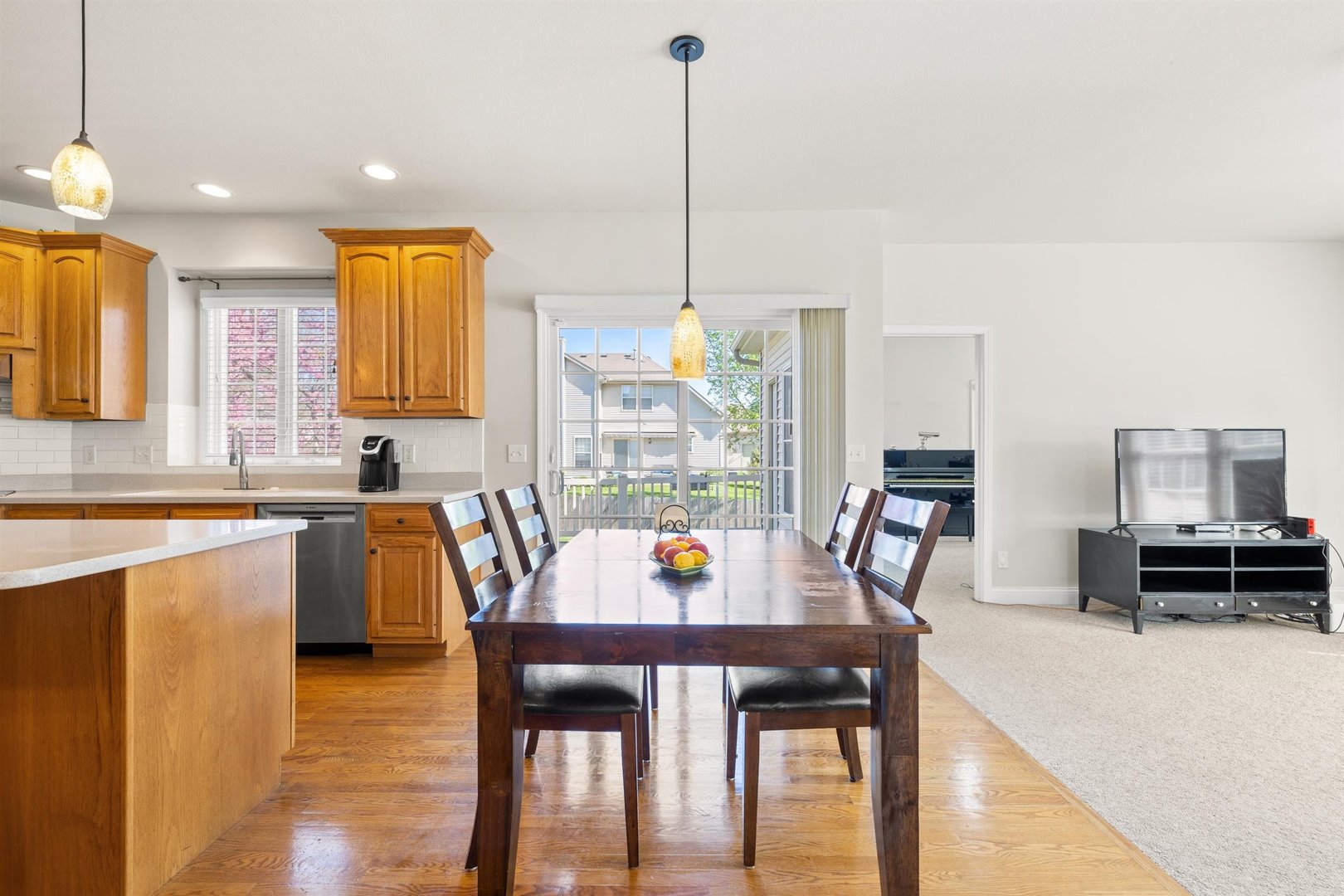 4512 Doverbrook Drive Champaign, IL 61822 - Photo 14 of 62 a kitchen with a dining table chairs and wooden floor