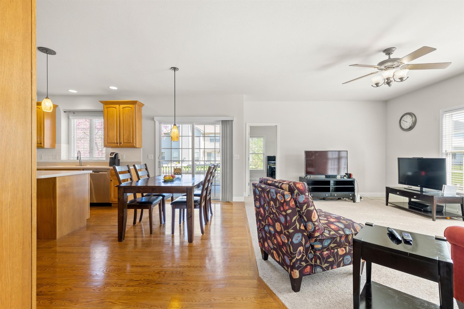 4512 Doverbrook Drive Champaign, IL 61822 - Photo 10 of 62 a dining room with furniture wooden floor a rug and a chandelier