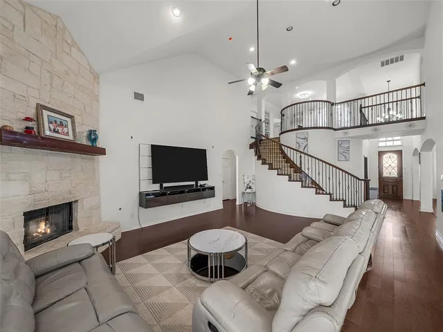 a kitchen with stainless steel appliances granite countertop a sink a stove a refrigerator and island