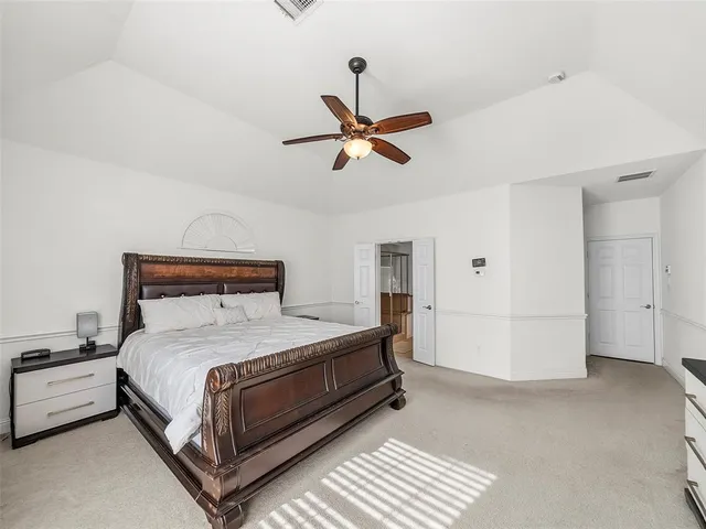 a bathroom with a granite countertop sink a mirror and a bathtub