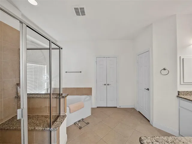 a bathroom with a shower and a tub