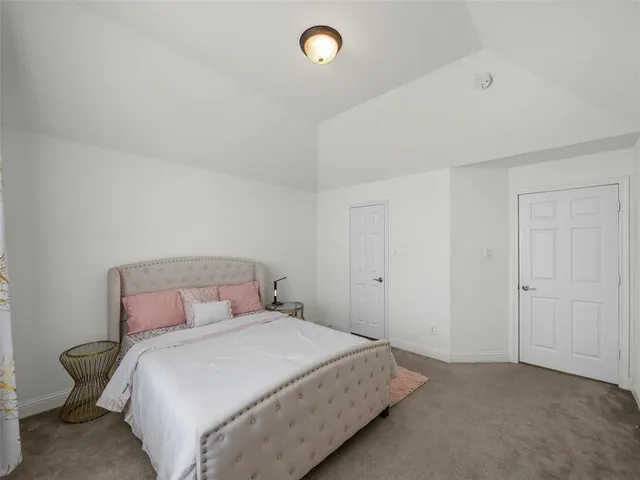 a bedroom with two beds and a window