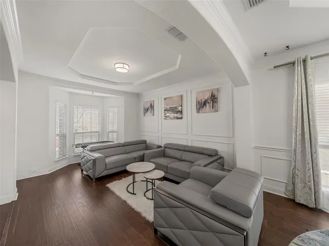 a view of entryway livingroom and hall with wooden floor