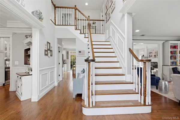 a view of entryway and hall with wooden floor