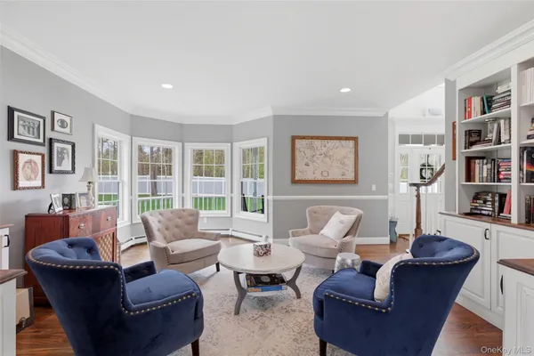 a living room with furniture and a book shelf