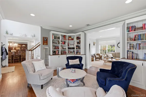 a living room with furniture and a book shelf