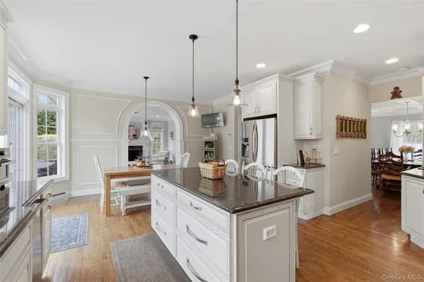 a view of living room with granite countertop furniture and wooden floor