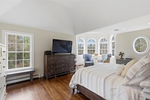 a bedroom with a large bed and a window